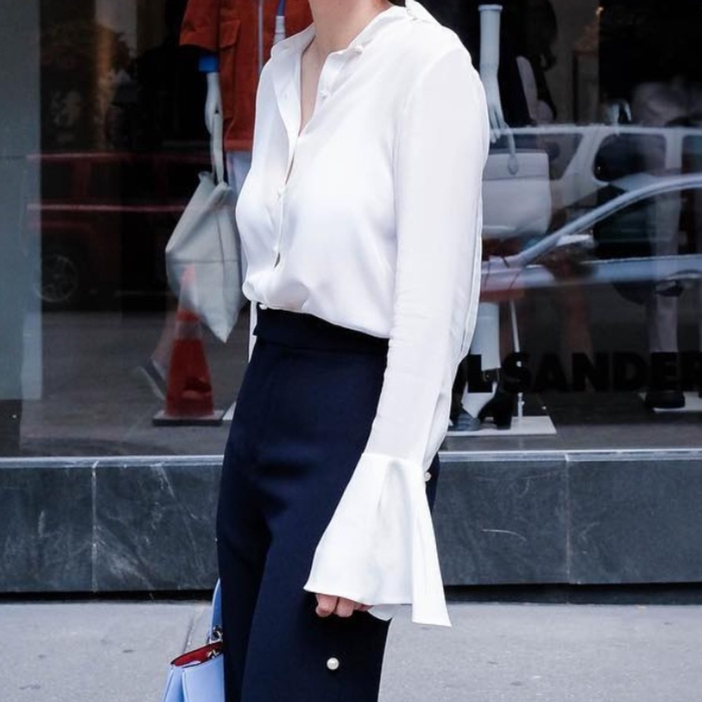 Elegant white blouse with pearl button